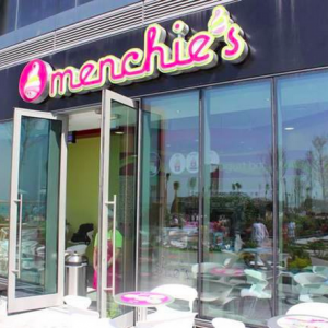 An open door is ready to welcome guests into a Menchie's location.