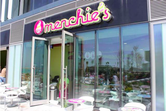 An open door is ready to welcome guests into a Menchie's location.