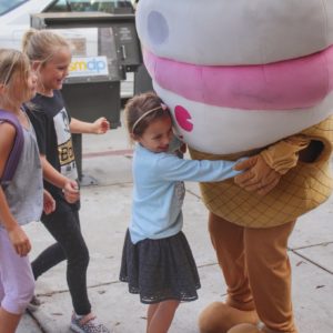 Children hug the Menchie’s mascot in our Sherman Oaks, CA, location.