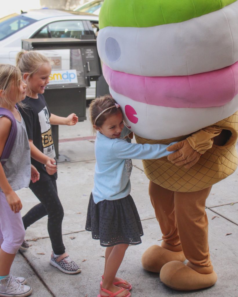 Children hug the Menchie’s mascot in our Sherman Oaks, CA, location.