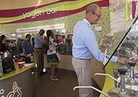 A guest selects toppings to put on his Menchie’s frozen yogurt.